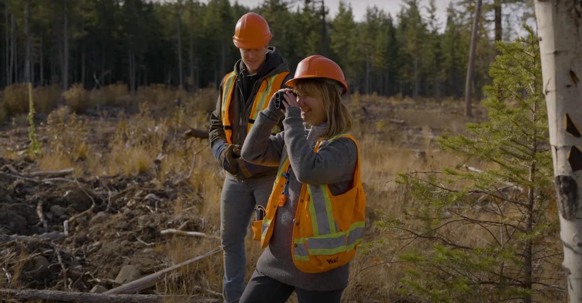 Two Firesmart workers in a forest surveyo